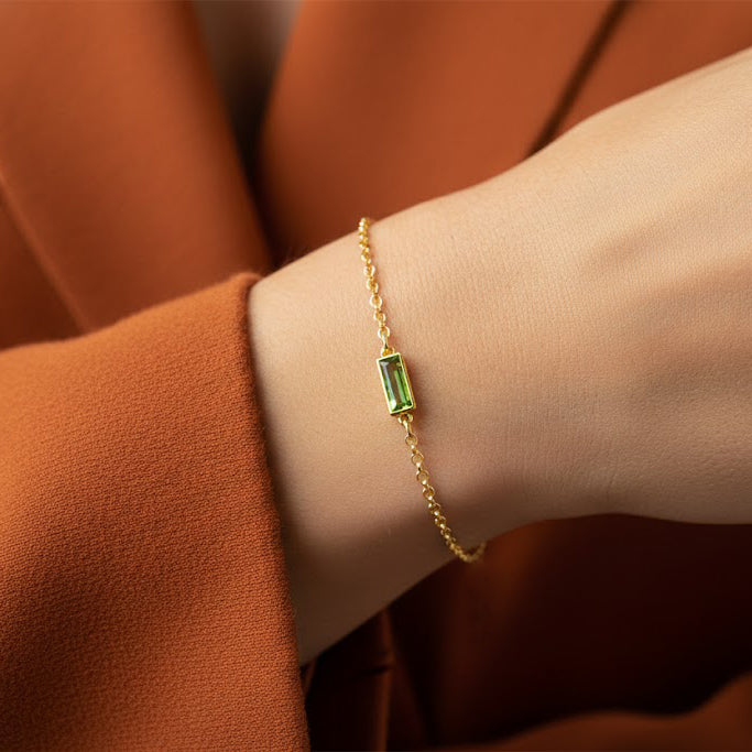 Dainty engraved birthstone bracelet close-up on wrist, elegant gold filled adjustable chain with rectangular gemstone connector, personalized jewelry gift for women, meaningful single birthstone bracelet for daughter, mom or wife.