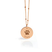 Rose gold disc pendant necklace featuring an engraved dog paw print and the name “Troy,” personalized pet memorial jewelry, custom engraved keepsake for pet lovers, unique sympathy gift for dog or cat owners, elegant and minimalist design available in multiple chain styles and lengths, perfect for daily wear or special remembrance occasions.