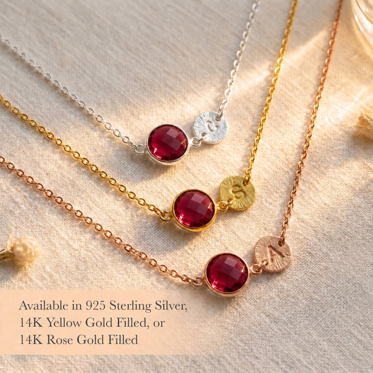 Ruby initial necklaces displayed in sterling silver, yellow gold, and rose gold finishes