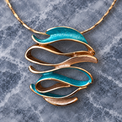 Close up of Ocean Breeze Sculptural Wave pendant with teal and warm metallic abstract curves
