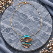 Full Ocean Breeze Sculptural Wave pendant necklace with adjustable chain on gray stone
