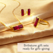 Birthstone jewelry gift set featuring a gold necklace, matching stud earrings, and coordinating ring with rectangular ruby birthstones displayed on soft satin fabric. Elegant birthstone gift set designed for meaningful gifting, perfect for birthdays, anniversaries, Mother’s Day, or Valentine’s Day. Personalized gemstone jewelry set ready for gift giving, ideal for women who love timeless, minimalist birthstone jewelry with a luxurious presentation.