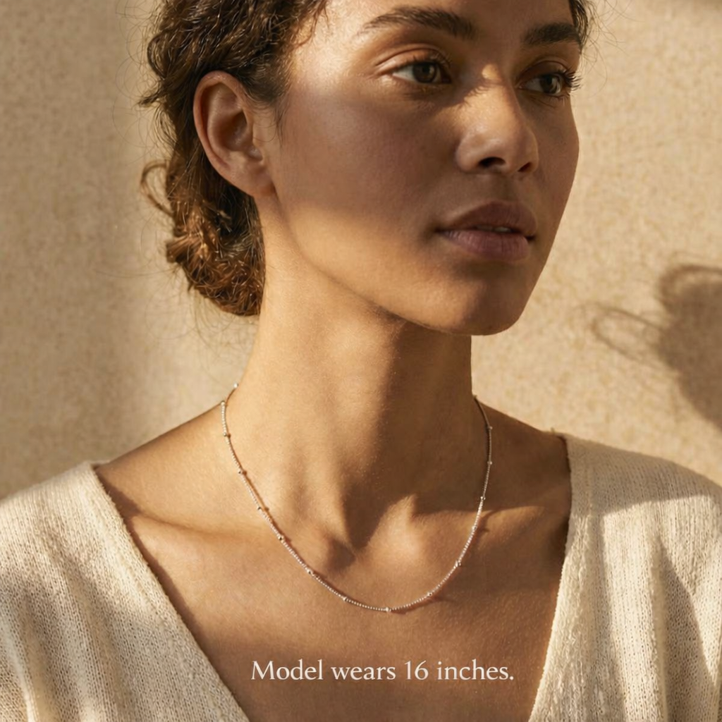 Model wearing the Dew Drops choker necklace styled at a 16 inch length, showing how the delicate satellite chain sits at the collarbone for a modern minimalist look, perfect for everyday wear or layering with other fine necklaces