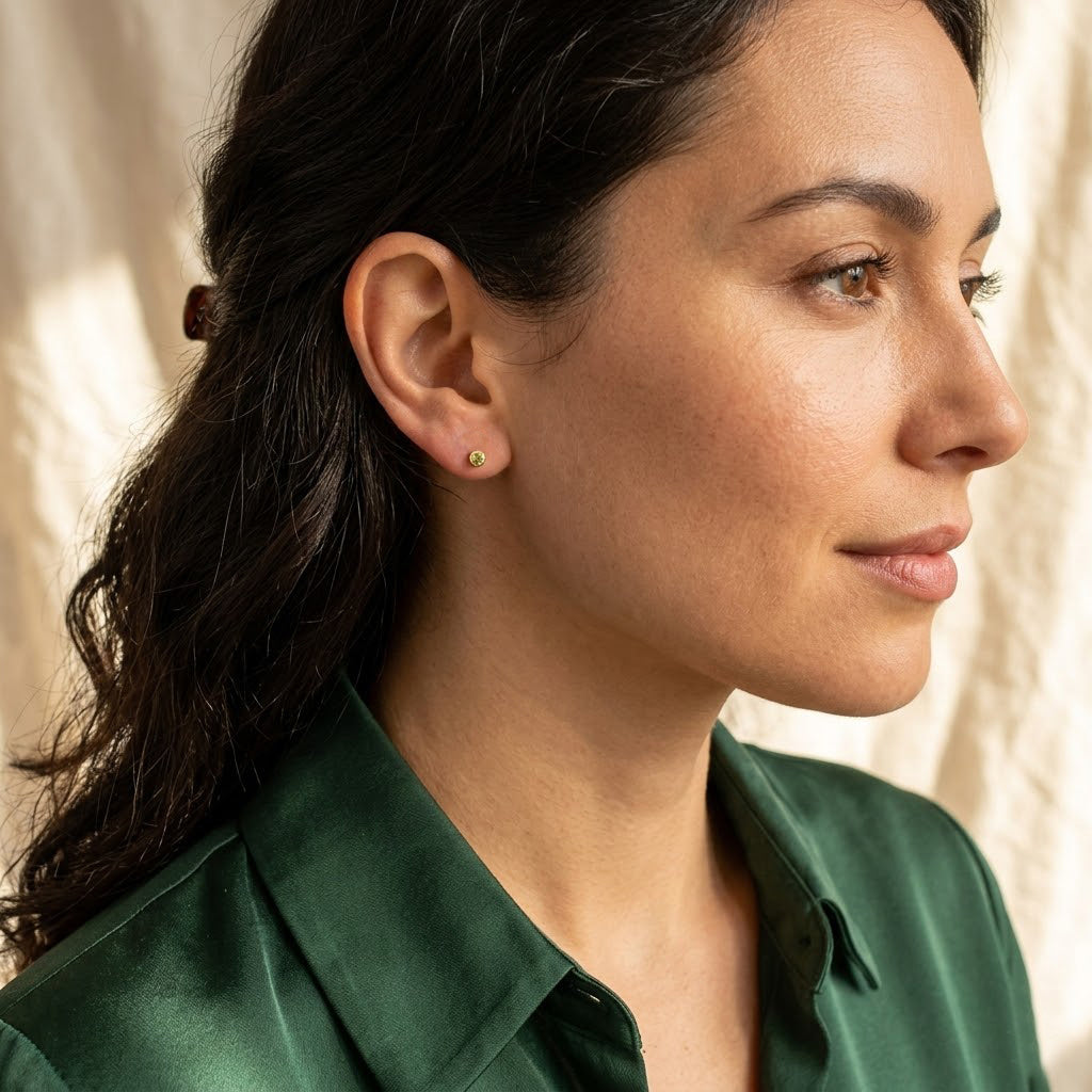 Model wearing tiny custom birthstone stud earrings, a minimalist personalized gemstone earring gift for birthdays, bridesmaids, moms, sisters, or friends.