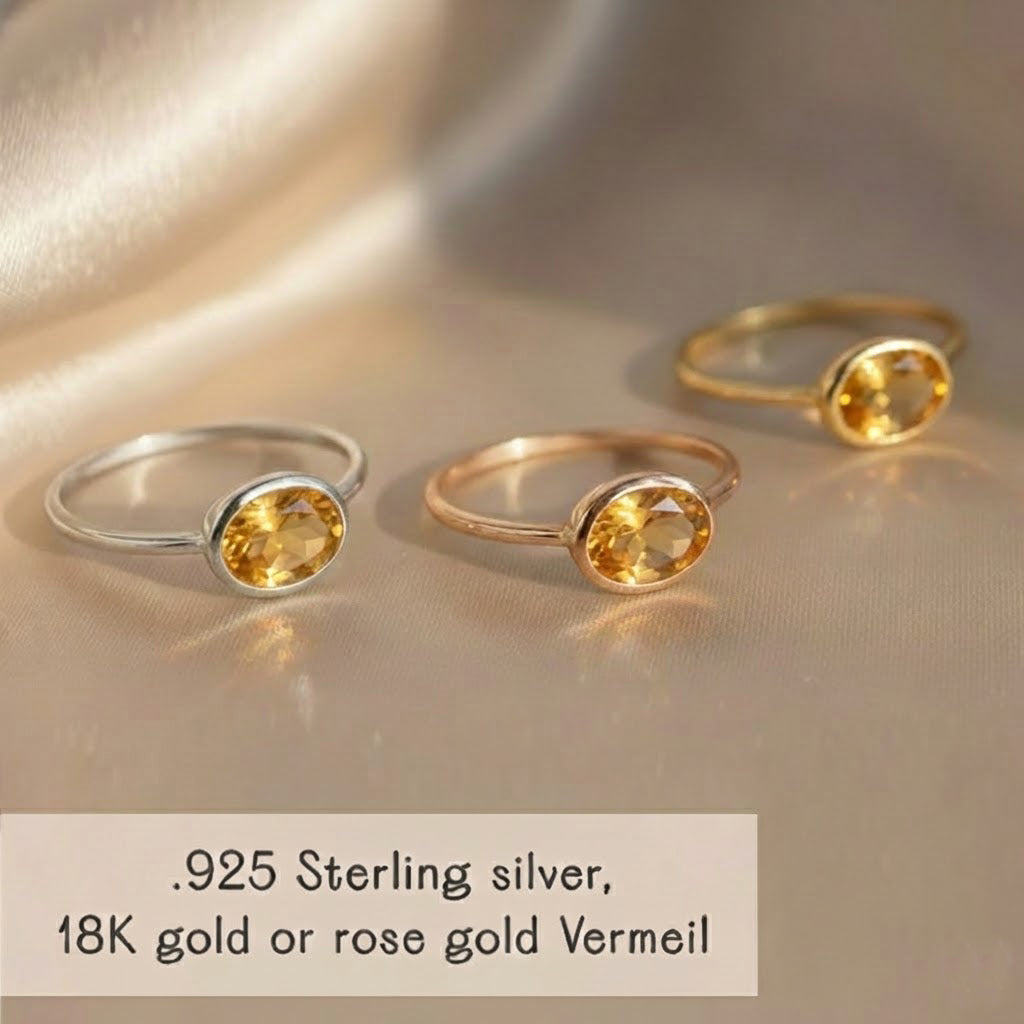 Close-up of a small oval citrine gemstone set in a minimalist birthstone ring, showcasing natural November birthstone color. Available in sterling silver, yellow or rose vermeil gold