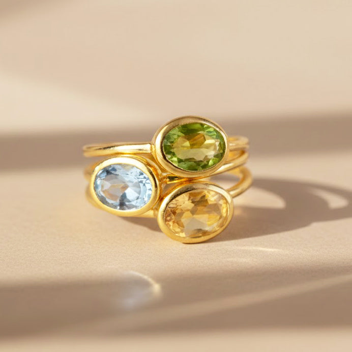 Stackable oval birthstone rings in sterling silver and vermeil gold with aquamarine for March, peridot for August, and citrine for November. Personalized stacking gemstone rings for moms, daughters, or women’s everyday jewelry, available in all 12 birthstones.