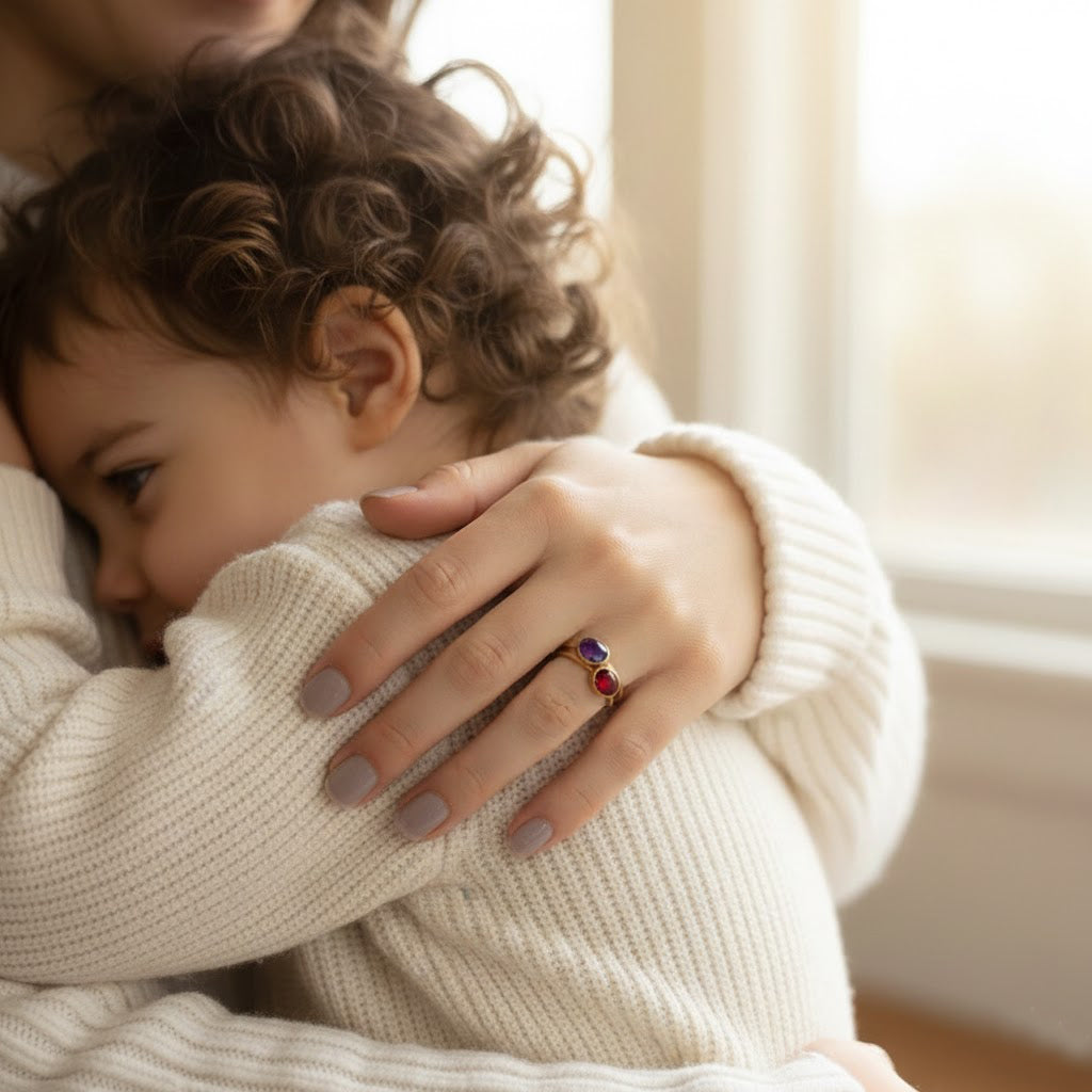 Mother and child moment wearing birthstone ring, sentimental stacking birthstone jewelry symbolizing family love, meaningful gift for mom, new mom, or grandmother with personalized gemstones