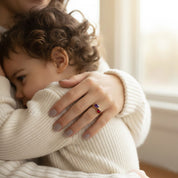 Mother and child moment wearing birthstone ring, sentimental stacking birthstone jewelry symbolizing family love, meaningful gift for mom, new mom, or grandmother with personalized gemstones