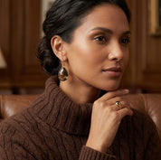 Model wearing smoky quartz earrings with warm brown gemstone and gold setting