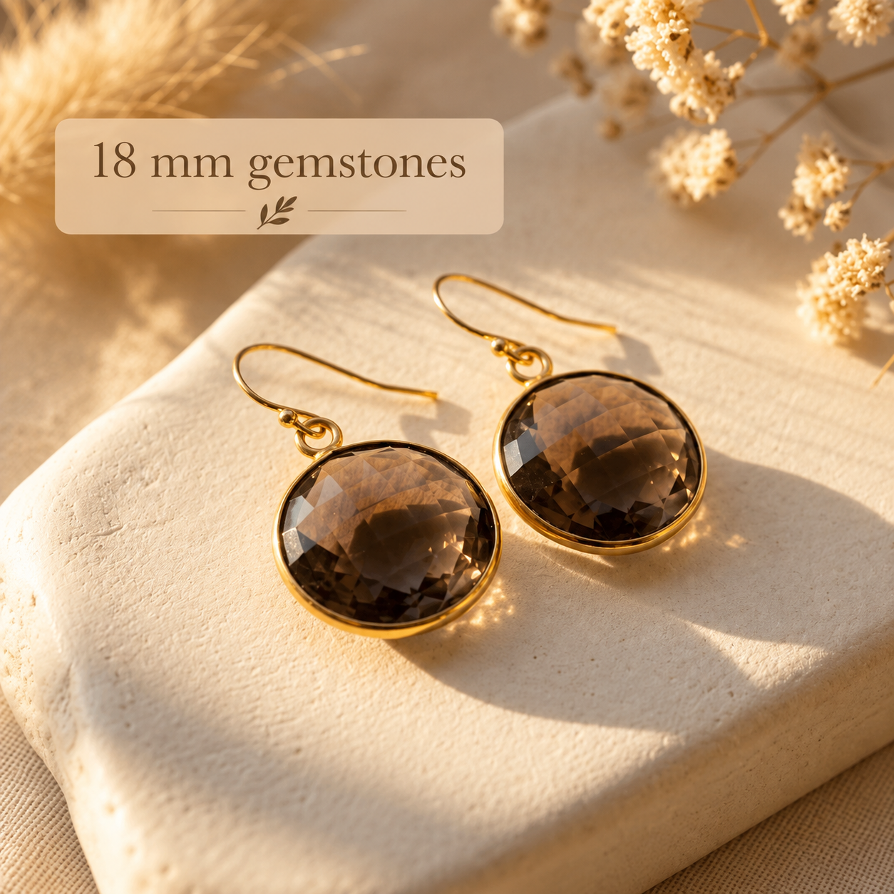 Large round Smoky Quartz earrings with 18 mm faceted brown gemstones in yellow gold settings.
