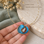 Hand holding Ocean Breeze custom color Sculptural Loop pendant necklace showing 30mm size

