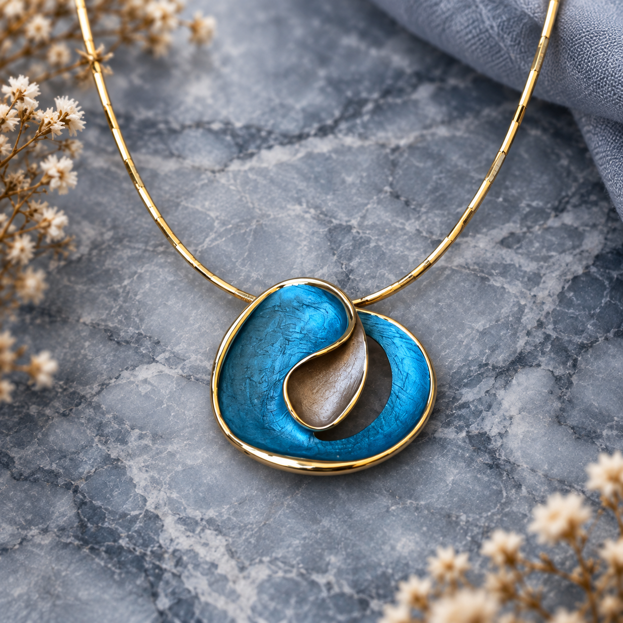 Ocean Breeze Sculptural Loop abstract pendant necklace displayed on gray stone

