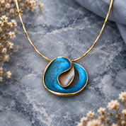 Ocean Breeze Sculptural Loop abstract pendant necklace displayed on gray stone

