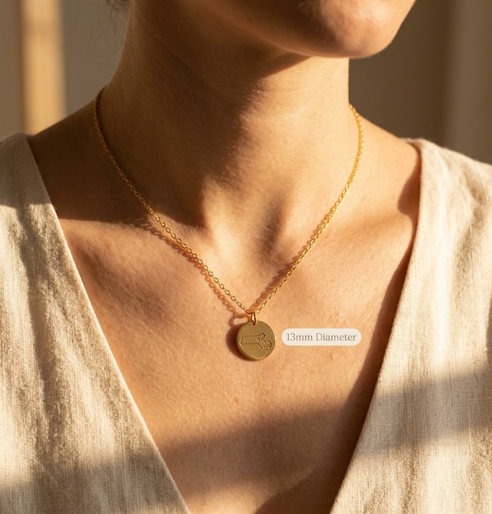 Woman wearing engraved state necklace with heart location marker
