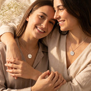 Friends wearing personalized state map necklaces as meaningful gifts