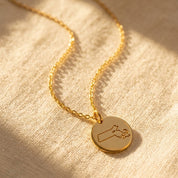 Personalized state map necklace with heart marking hometown in yellow gold
