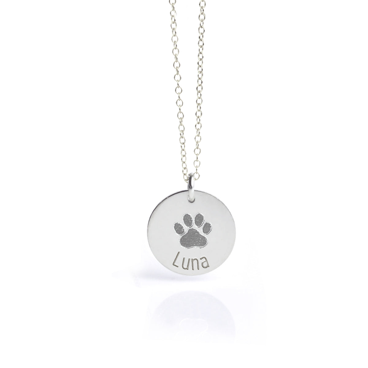 Sterling silver disc pendant necklace engraved with a detailed dog paw print and the name “Luna,” personalized pet remembrance jewelry, custom pet loss sympathy gift for dog or cat owners, unique keepsake necklace with minimalist design, available in multiple chain lengths for everyday wear or special occasions.