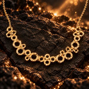 Gold boho connected circles statement necklace displayed on dark textured stone