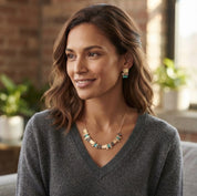 Woman wearing aqua and neutral stacked squares statement necklace and matching stud earrings

