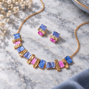 Custom color stacked squares necklace and matching stud earrings in blue pink gold and rose gold on marble

