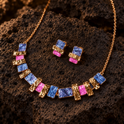 Colorful stacked squares necklace and matching studs in blue pink and gold on dark textured stone
