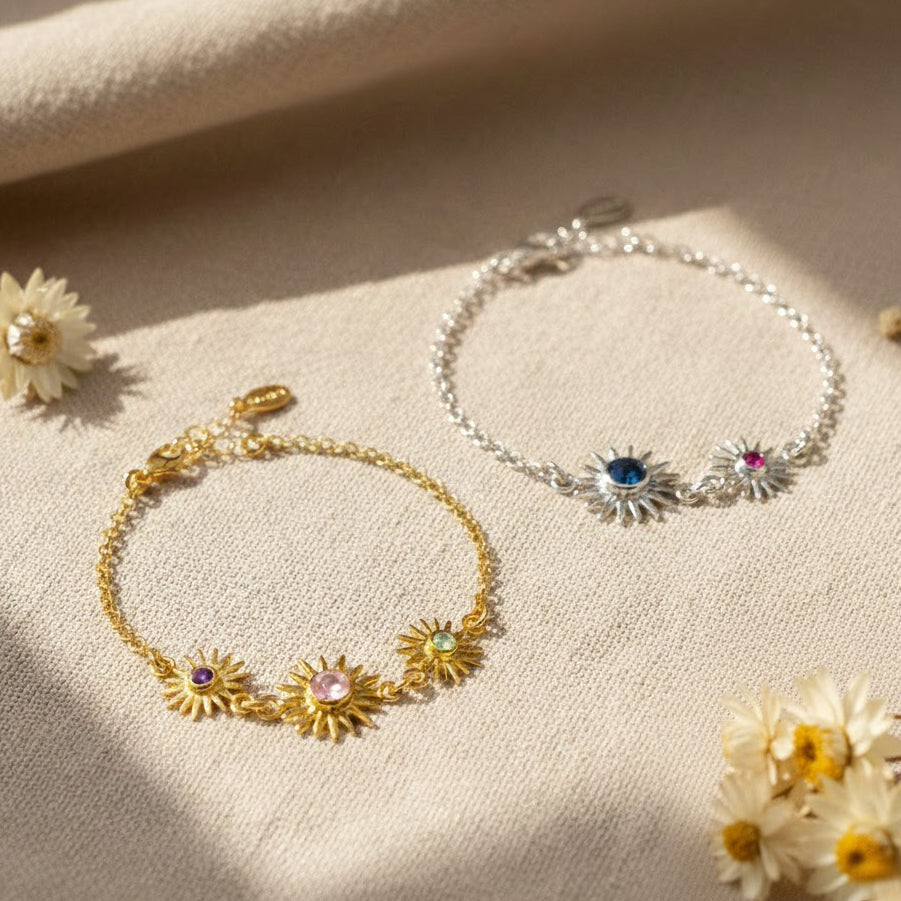 Collection of custom sunburst birthstone bracelets with various gemstone colors and metal finishes. Personalized family jewelry designed for moms and grandmas.