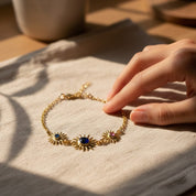 Sunburst birthstone bracelet shown on wrist to demonstrate size and scale, featuring a 5mm gemstone for mom and 3mm gemstones for children. Personalized family bracelet designed for comfortable everyday wear.