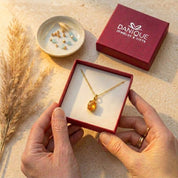 Orange gemstone necklace with natural sunstone oval pendant in danique jewelry branded box