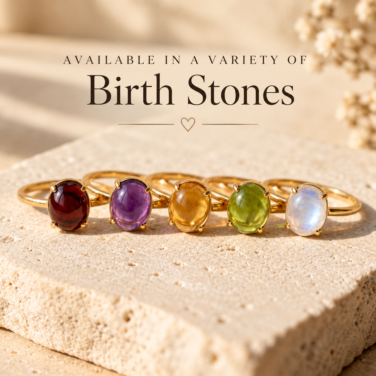 Oval cabochon birthstone rings shown in multiple gemststones