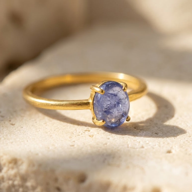 Natural Tanzanite oval cabochon ring in yellow gold vermeil with petite blue violet December birthstone.

