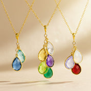Personalized birthstone necklace for mom and grandma featuring multiple teardrop birthstones on a gold vermeil chain, custom family jewelry with January garnet, February amethyst, March aquamarine, April diamond quartz, May emerald, and June pearl stones, meaningful mother necklace with children’s birthstones, sentimental gift for mom, grandma necklace with grandkids, handmade minimalist family birthstone jewelry