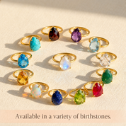 Collection of teardrop birthstone rings in colorful gemstone options, showing opalite and other birthstone rings available in a variety of stones.