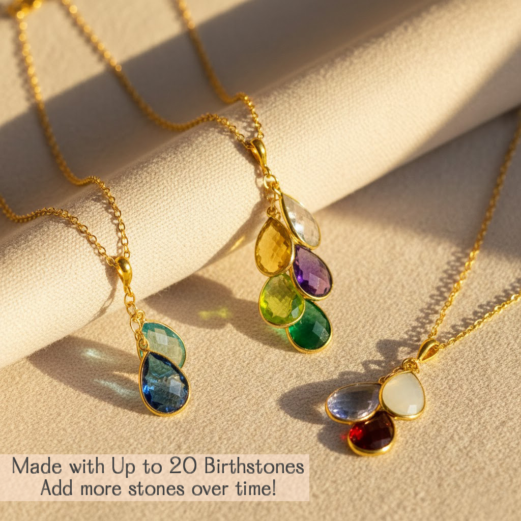 Personalized teardrop birthstone necklace for mom with sparkling natural gemstones arranged in a cascading cluster, handcrafted in sterling silver or gold, designed to celebrate children, family milestones, and growing generations.