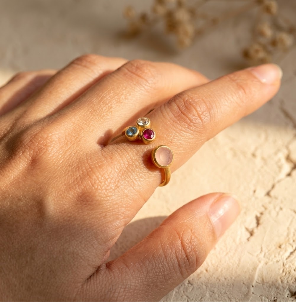 Personalized mom and three kids birthstone ring worn on hand with four custom family gemstones