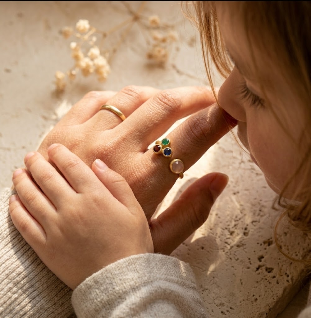 Woman wearing custom mom of three birthstone ring with personalized family gemstones on her hand