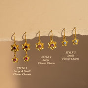 Custom birthstone flower drop earrings displayed in multiple gemstone colors, floral bloom charm earrings showing all 12 birthstone options from January to December, personalized jewelry gift for mom, grandma, or bridesmaids