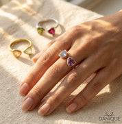 Two birthstone bow tie ring worn with purple and blue triangle gemstones
