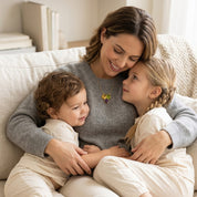 Mother wearing a personalized three birthstone necklace while cuddling with her children, thoughtful gift for Mother’s Day or birthdays.