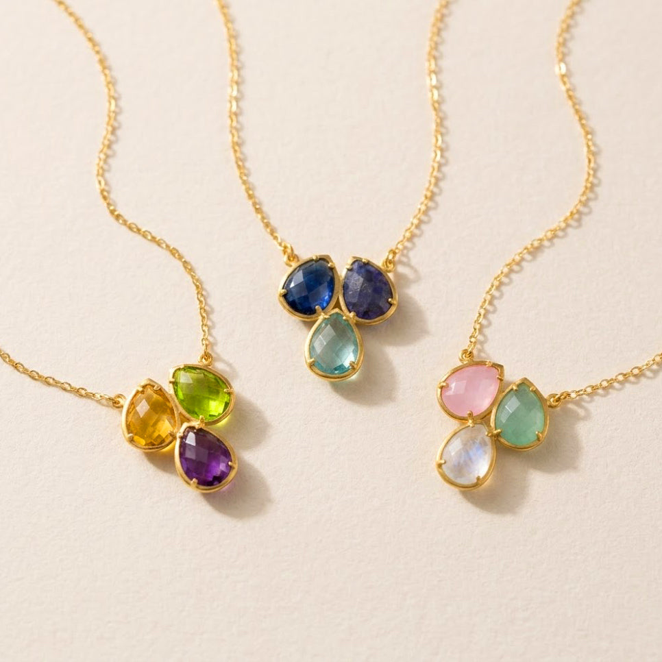 Three birthstone necklace shown in different gemstone combinations on gold chains, custom family jewelry for moms and grandmothers.