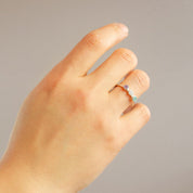 Triple Birthstone Ring for mom on models hand. Great gift for Christmas in Vermeil Gold on a white background. Personalized Birthstone Rings for Mom of three, Perfect gift for Mother's Day. December Birthstone, November Birthstone, and September Birthstone Dainty Bezel Set Ring. January Birthstone, June Birthstone, and February Birthstone Custom Ring with Kids Birthstones. Blue Topaz, Citrine and Kyanite Ring. Garnet, Rainbow Moonstone, and Purple Amethyst Ring