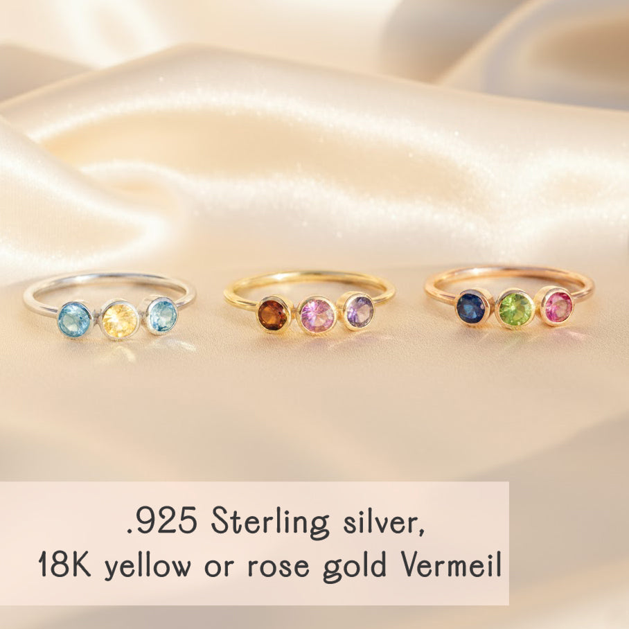 Trio birthstone mom rings displayed on soft satin background, featuring delicate three-stone bands in .925 sterling silver, 18k yellow gold vermeil, and 18k rose gold vermeil with sparkling bezel-set gemstones representing children or family members; customizable family birthstone ring perfect as a Mother’s Day gift, push present, or birthday jewelry for mom or grandma who loves dainty, minimalist stacking rings and meaningful personalized keepsakes.