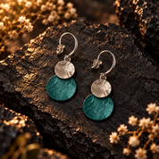 Teal Green and Silver hammered double disc earrings displayed on dark textured stone

