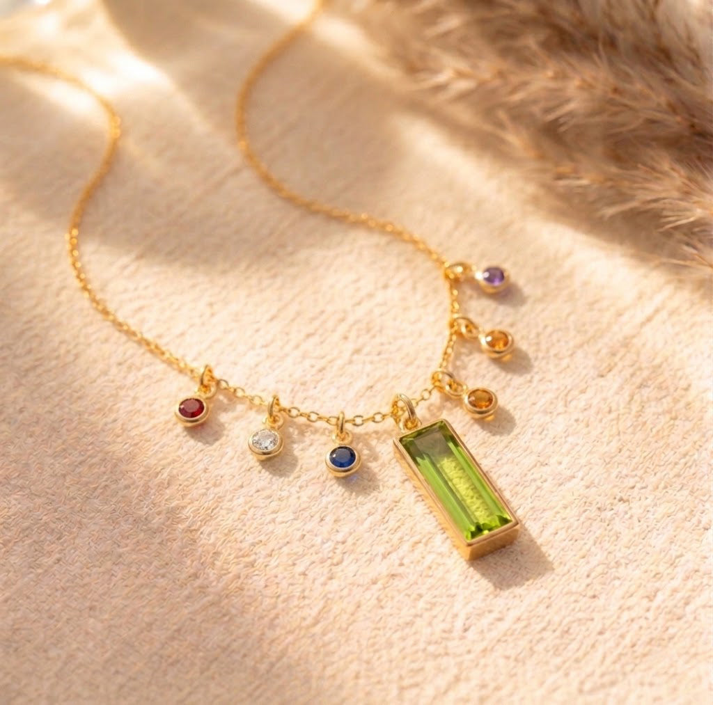 Close-up of custom mother’s birthstone necklace with engraved rectangular pendant and delicate birthstone charms, a sentimental necklace for mom or grandma.
