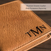 Close up of custom monogram engraved leather wallet showing deep laser engraving detail on natural grain leather surface