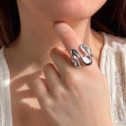 Model wears silver textured wave shaped ring on index finger. Stretchy ring, adjustable to fit ring, wave ring, nature inspired jewelry, boho jewelry, nature inspired ring, ocean ring, water ring, bohemian jewelry, zinc alloy, gold, silver, one size fits most, ring for her, mother's day git, christmas gift, gift for girlfriend