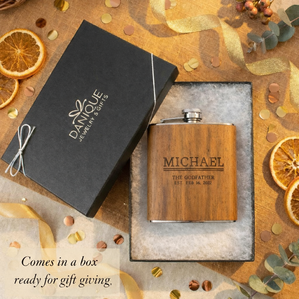Personalized engraved wooden flask displayed inside a Danique Jewelry gift box, featuring custom name and meaningful text engraved on natural wood. Flask is presented in elegant gift-ready packaging with a subtle message indicating it comes boxed and ready for gift giving. Thoughtful custom whiskey flask gift for him, godfather, dad, husband, or groomsmen, perfect for birthdays, weddings, anniversaries, or Valentine’s Day gifting.
