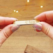 A person holds a birch white wood tie clip engraved with initials and a heart symbol. Custom engraved tie bar for men, custom tie tack, personalized tie bar, custom engraved tie tacks for men, unique men's accessories for outdoor wedding, custom outdoor wedding accessories