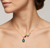Woman wearing personalized family birthstone necklace for mom with teardrop pendant