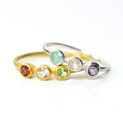 Two Dainty Triple Birthstone Rings for Mom. 925 Sterling Silver Ring Bezel Set with March Birthstone Aqua Chalcedony, October Birthstone Opalite, and February Birthstone Purple Amethyst. Vermeil Gold Three Birthstone Ring Bezel Set with January Birthstone Garnet, April Birthstone Clear Quartz, and August Birthstone Peridot