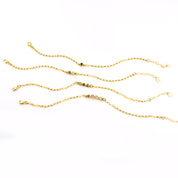 Four anklets that can be mixed and matched and layered! One anklet with black onyx gemstone. One anklet with garnet and clear gemstones. One anklet with peridot, garnet and peridot stones. One gold anklet with garnet, ruby, pink chalcedony and clear stones. 